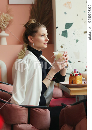 young blond business woman on lunch in cafe drinking latte coffee closeup photo 96890309