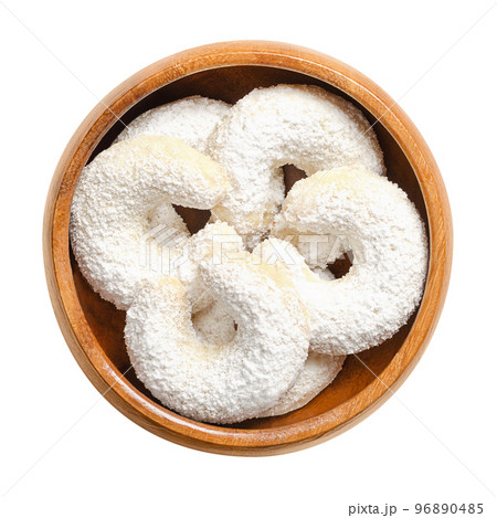 Vanilla crescents, Vanillekipferl in a wooden bowl. Crescent shaped Christmas biscuits, originally from Austria, traditionally made with walnuts, butter and flour, heavy dusted with vanilla sugar. 96890485
