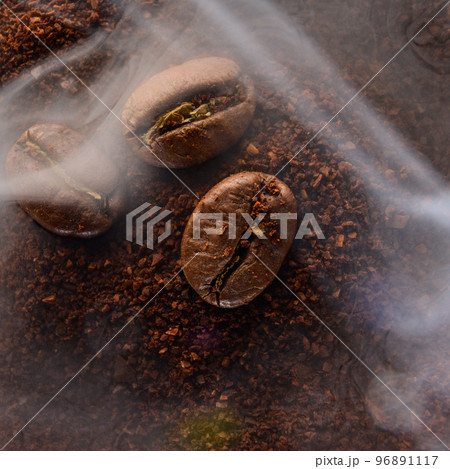 Ground coffee and coffee beans, coffee in light smoke. 96891117