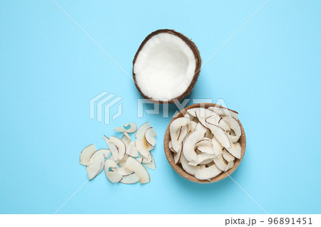 Flat lay composition with tasty coconut chips on light blue background Flat lay composition with tasty coconut chips on light blue background 96891451