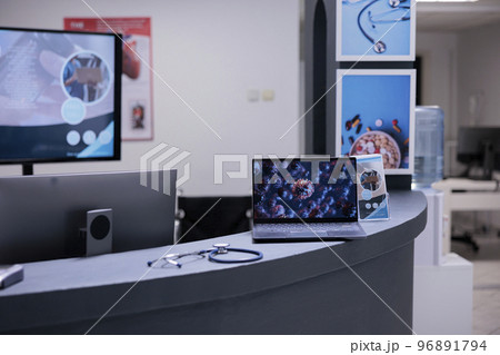 Coronavirus vaccination center showing illustrative images of covid 19 cell on laptop screen at administrative area. Medical clinic informing about coronavirus symptoms through representation on Coronavirus vaccination center showing illustrative images of covid 19 cell on laptop screen at administrative area. Medical clinic informing about coronavirus symptoms through representation on 96891794