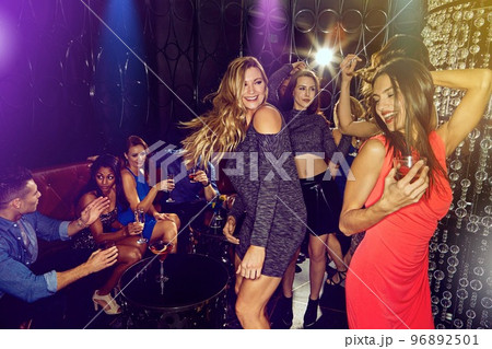 Night club, party and friends dance in disco for new years eve celebration, VIP event and social drinking with music, energy and cocktails. Group of people, dancing and celebrate freedom in nightclub 96892501