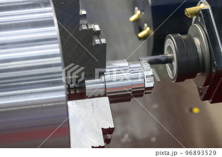 The multi-tasking CNC lathe machine milling cutting the metal shaft parts by milling turret. The multi-tasking CNC lathe machine milling cutting the metal shaft parts by milling turret. 96893529