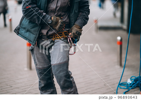 Worker climber preparing for work at height. Worker climber preparing for work at height. 96893643