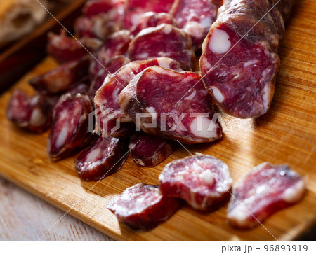 Traditional French dried sausage on cutting board Traditional French dried sausage on cutting board 96893919