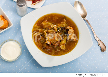 Soup of cabbage with boiled vegetables and pork broth, served in plate Soup of cabbage with boiled vegetables and pork broth, served in plate 96893952
