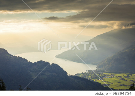 Aerial view of Swiss Alps and Lake Thun at dramatic sunset, Interlaken Aerial view of Swiss Alps and Lake Thun at dramatic sunset, Interlaken 96894754