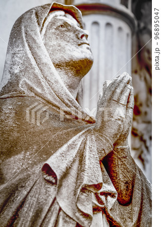 Faithfull Virgin Mary with praying hands and blessing, looking at the sky 96895047