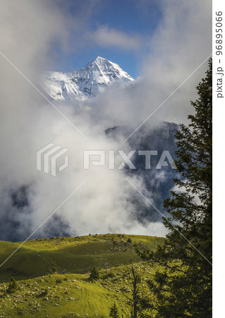 Misty Mountain above Grindelwald, Snowcapped Bernese Swiss alps, Switzerland Misty Mountain above Grindelwald, Snowcapped Bernese Swiss alps, Switzerland 96895066