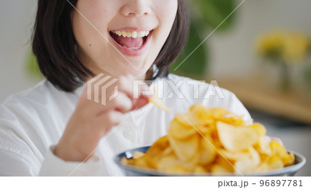 ポテトチップスを食べる女性（不健康・ダイエット）.. 96897781