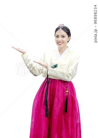 Asian woman wearing a traditional Korean national costume, Hanbok, standing with an open palms and showing something 96898234