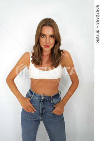 Beautiful attractive young woman with makeup posing in the studio on white 96902606