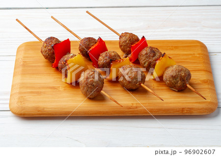 Bbq kebabs on the skewers served on wooden board. 96902607