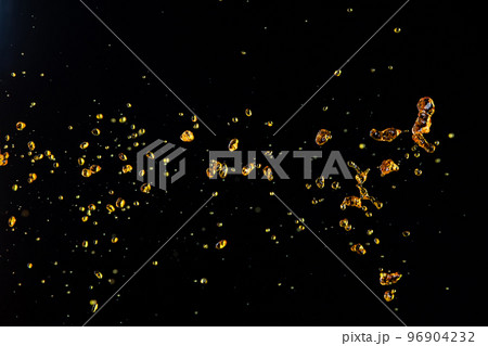 Orange, lemon juice or oil lubricant splash, liquid gold yellow drink drops. Fruit beverage water elements in line form . Fresh splashing and flowing jets, black background isolated freeze motion 96904232