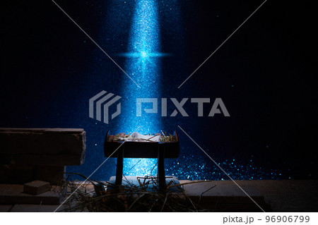 Nativity of Jesus, empty manger at night with bright lights. 96906799