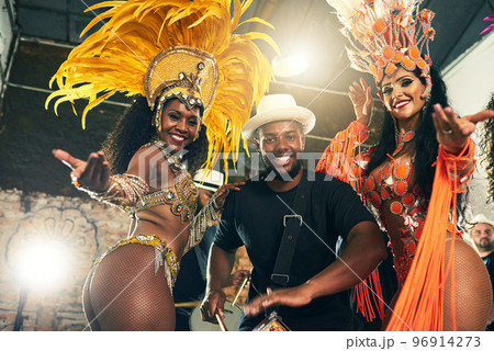 Carnival, brazil and band with woman dancers outdoor together for a new year celebration in rio de janeiro. Portrait, party and event with a man and female performance artists celebrating tradition 96914273