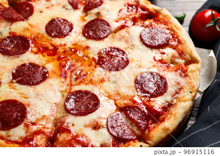 Hot delicious pepperoni pizza on table, closeup Hot delicious pepperoni pizza on table, closeup 96915116
