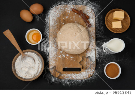 Flat lay composition with dough and other ingredients on black table. Baking pie 96915845