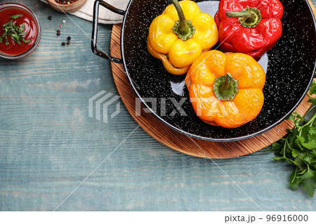 Tasty stuffed bell peppers on blue wooden table, flat lay 96916000