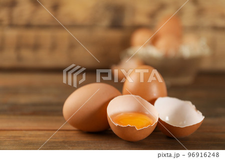 Raw brown chicken eggs on wooden table. Space for text 96916248