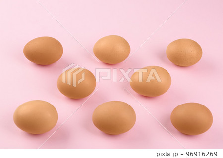 Raw chicken eggs on pink background, flat lay Raw chicken eggs on pink background, flat lay 96916269