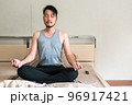 Man Meditating on the bed before sleep with copy space. 96917421