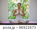 Asian happy woman folding hands doing yoga meditating at home. 96922673