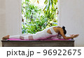 Young Asian woman doing yoga exercise at home. 96922675