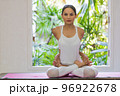 Young Asian woman doing yoga exercise at home. 96922678