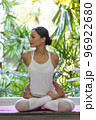 Young Asian woman doing yoga exercise at home. 96922680