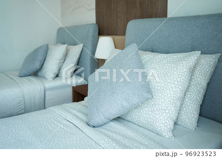 Apartment interior hotel with two single beds and bedside lamps 96923523