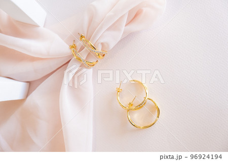 Hoop Earrings on pink background 96924194