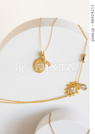 Golden necklaces on jewelry display stands. Golden necklaces on jewelry display stands. 96924211
