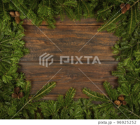 Close up fresh Christmas tree frame over wood 96925252