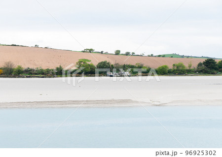 Sandy seashore. Calm water. The ship on the shore. Sandy seashore. Calm water. The ship on the shore. 96925302
