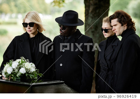 People standing by coffin at funeral ceremony People standing by coffin at funeral ceremony 96926419