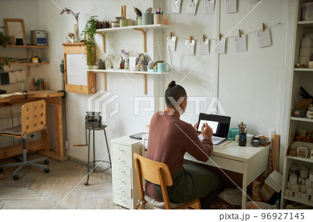 Artist working in cozy studio 96927145