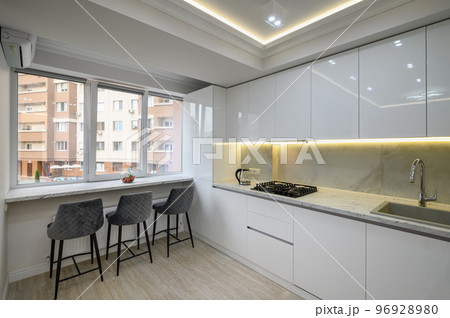 Interior of a modern white kitchen in a luxury studio apartmen Interior of a modern white kitchen in a luxury studio apartmen 96928980