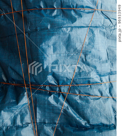 Blue crumpled synthetic fabric. 96933949