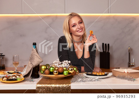 A woman with her hands eats a large appetizing shrimp. Selective focus. A woman with her hands eats a large appetizing shrimp. Selective focus. 96935293