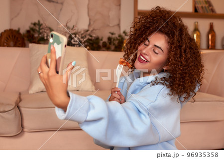 Young woman eating sushi at home. Home food delivery concept. Japan food. Top view. Space for text 96935358