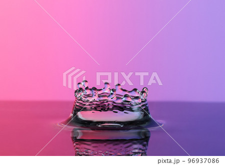 Water splash like crown on color background 96937086