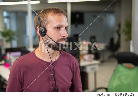 Caucasian bearded man with a headset. Male call center worker 96939628
