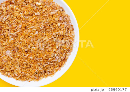 Dried chopped garlic on yellow background. Dried chopped garlic on yellow background. 96940177