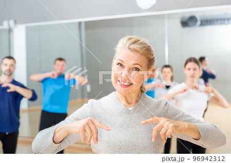 Mature woman practicing vigorous dance 96942312