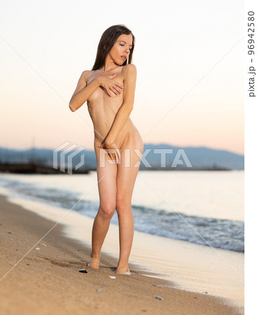 Nude photo of absolutely naked woman on beach 96942580