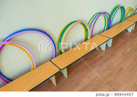Yellow benches inside a school sports gym. Yellow benches inside a school sports gym. 96943407