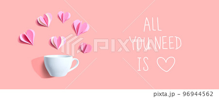 All you need is love message with a coffee cup and paper hearts All you need is love message with a coffee cup and paper hearts 96944562