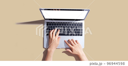 Person using a laptop computer 96944598