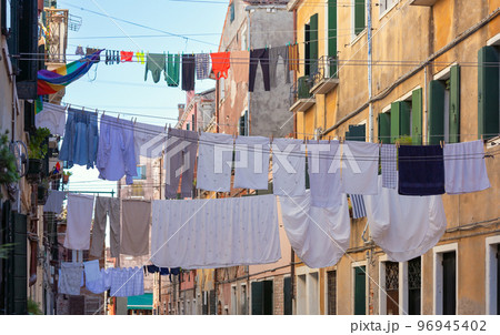 Laundry drying over an old narrow Venetian street. 96945402